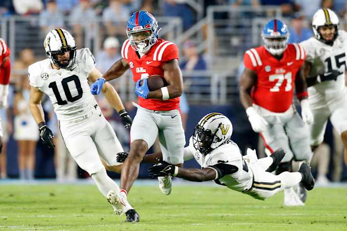 Oct 28, 2023; Oxford, Mississippi, USA; Mississippi Rebels running back Quinshon Judkins (4) runs the ball as Vanderbilt Commodores defensive back Savion Riley (21) dives to make the tackle during the first half at Vaught-Hemingway Stadium. Mandatory Credit: Petre Thomas-USA TODAY Sports